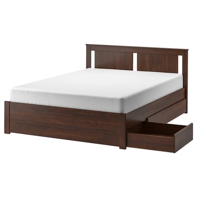 Dark brown SONGESAND bed with white mattress and under-bed storage.