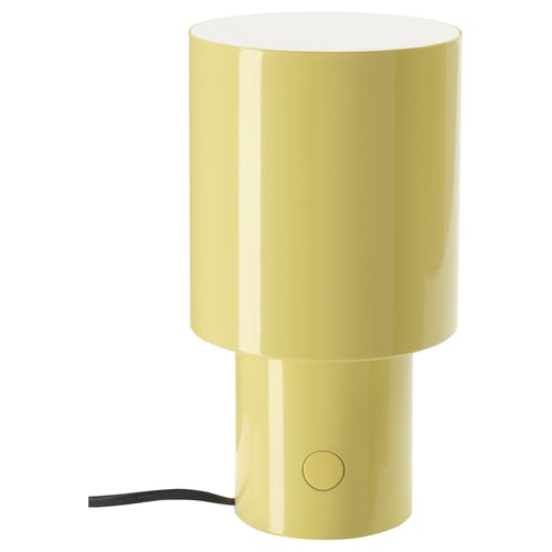 This image shows a yellow SPETSBOJ table lamp. Its cylindrical with a glossy finish, featuring a round switch on its side.
