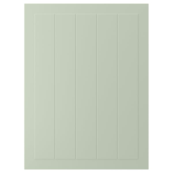 A green STENSUND cabinet door with vertical grooves. Its a rectangular shape made of fibreboard, smooth to touch.