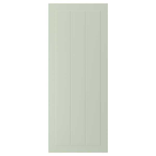 A green STENSUND cabinet door with a grooved panel design, made from fibreboard with a smooth, easy-to-clean finish.