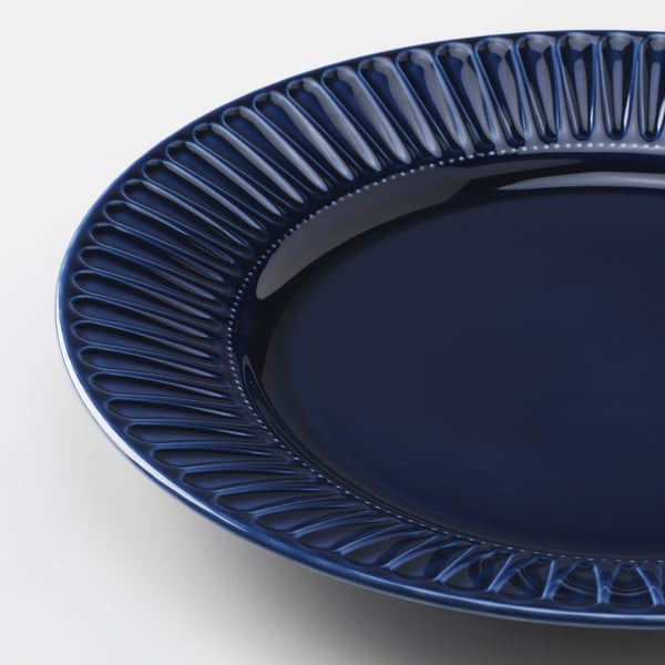 Blue plate, textured rim, glossy.