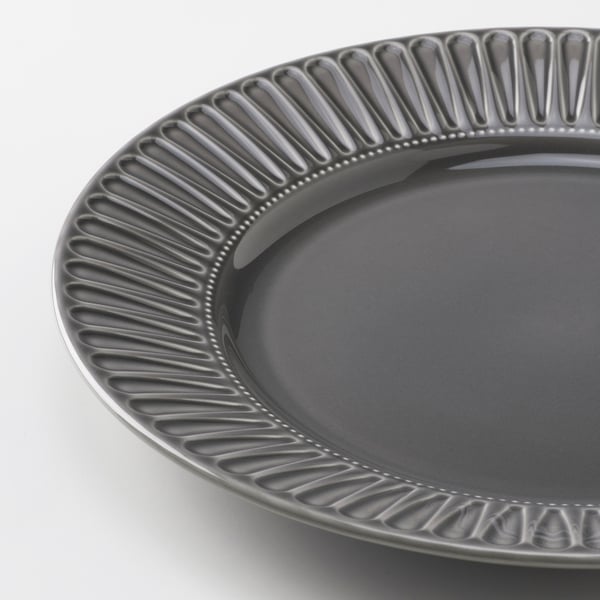 Modern dark grey plate with embossed linear patterns around edge. Smooth surface, sturdy build.