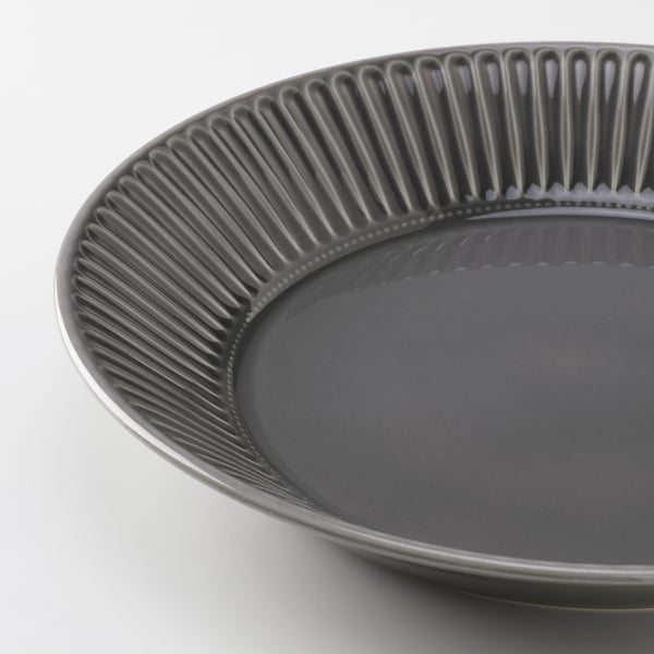 Close-up of a sleek, dark grey stoneware plate with intricate vertical grooves around the rim, showcasing a modern and elegant design.