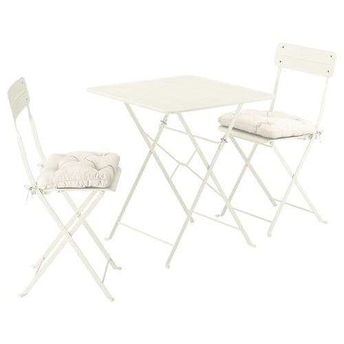 A white SUNDSÖ foldable outdoor table and two chairs. The set is compact, ideal for small spaces.