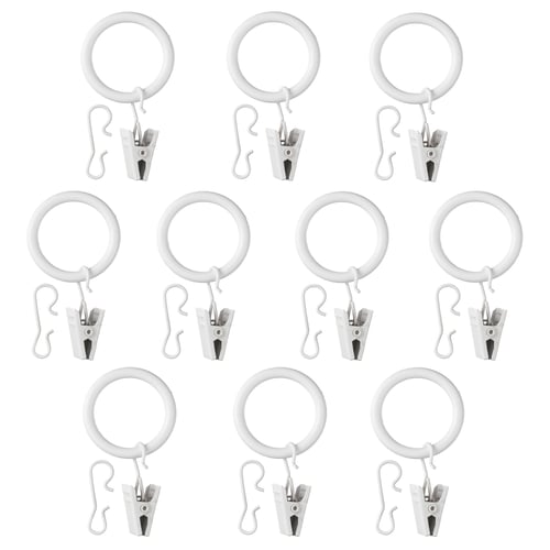 Multiple SYRLIG white curtain rings with hooks and clips arranged neatly.