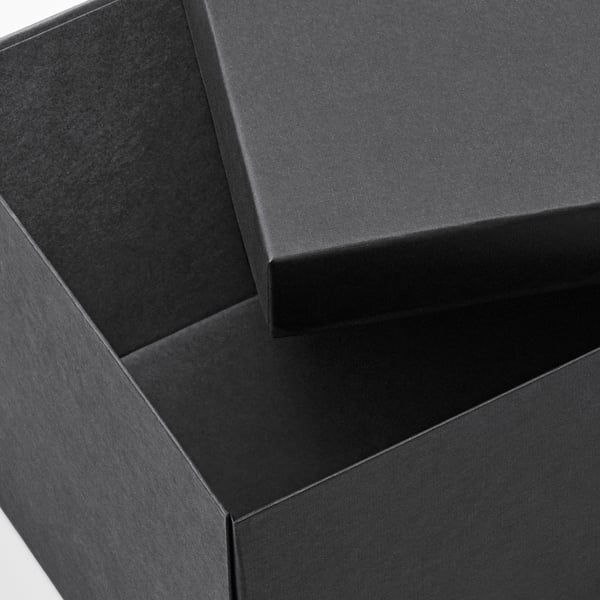 Black cardboard boxes, neatly stacked. High-quality recycled material, ideal for storage.
