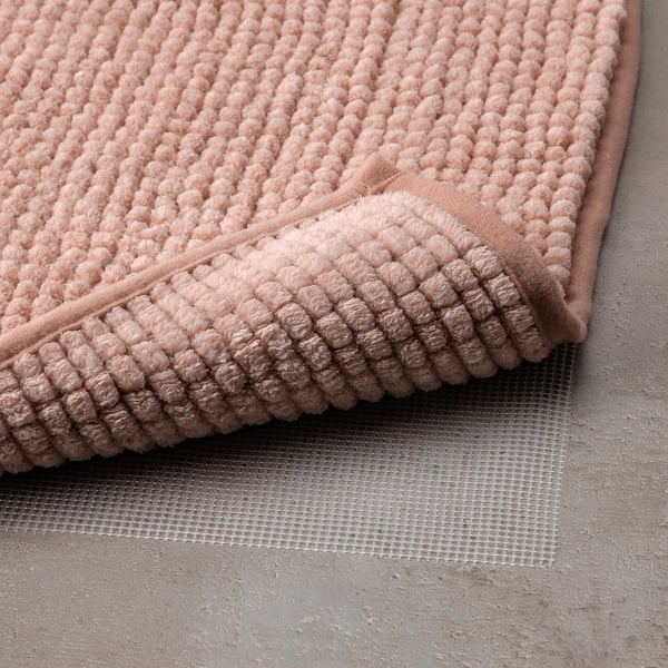 A plush, light-weight, and quick-drying bath mat with a non-slip mesh bottom.
