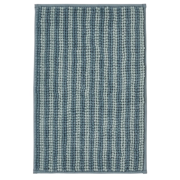 The TOFTBO bath mat is blue, rectangular, and plush with a round textured pattern. Made of recycled polyester for softness and quick drying.