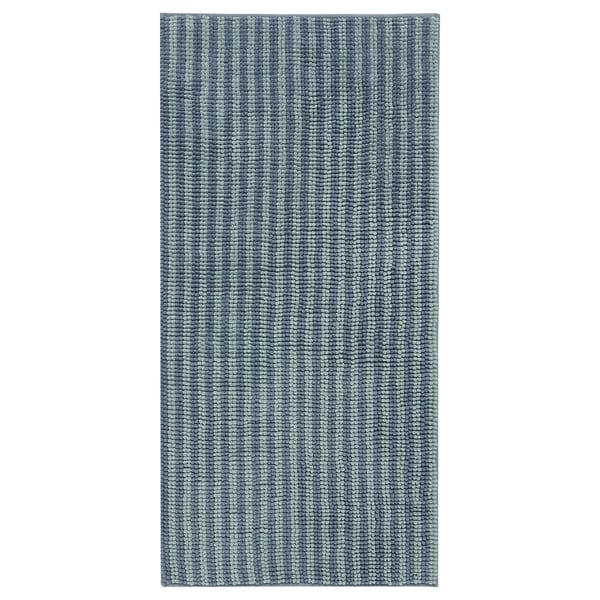 A blue TOFTBO bath mat. Its rectangular, plush, and made from recycled polyester.