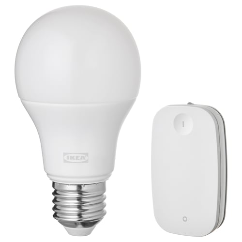 A white ikea TRÅDFRI smart light bulb and remote control. The bulb is spherical and the remote is rectangular, both are white.