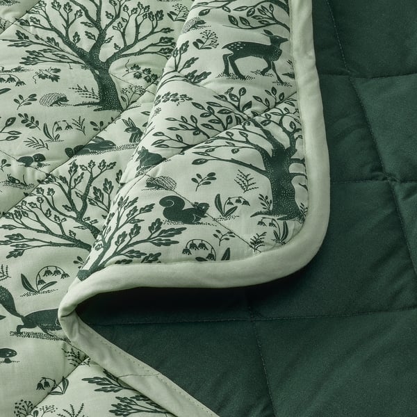 Forest-themed baby quilt, soft, recycled polyester filling, sustainably sourced cotton.