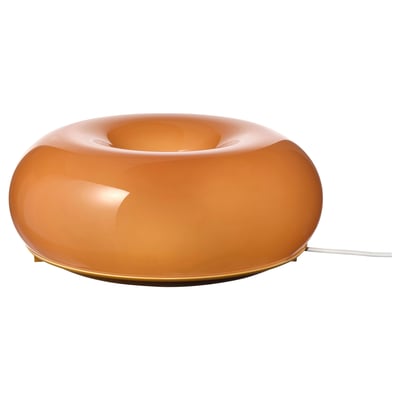 An orange, donut-shaped lamp called värmblixt, with a sleek, modern design and a warm, inviting glow.