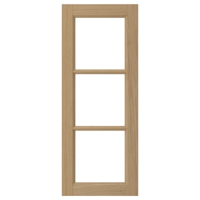 A VEDHAMN kitchen cabinet door in natural oak wood with glass panels framed by solid oak.