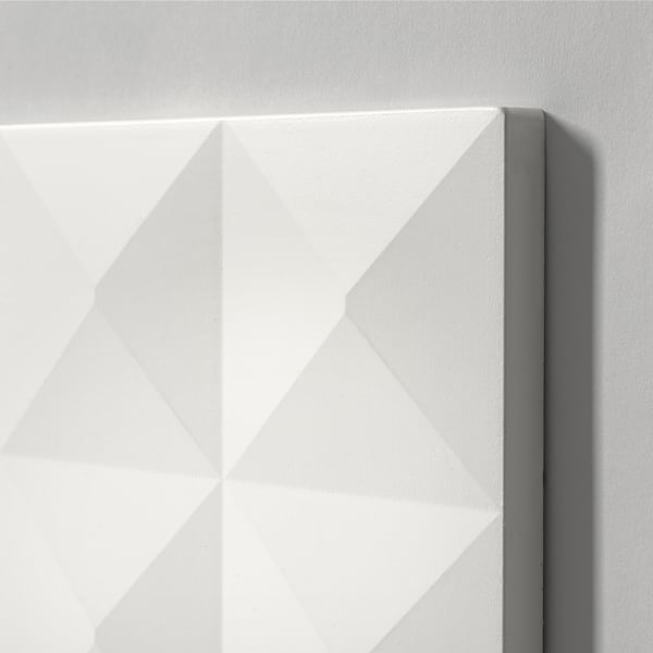 White textured panel, diamond pattern, mounted on wall.