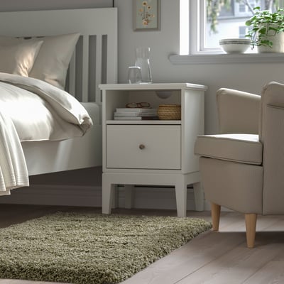 Bedroom: white bed, VOLLERSLEV rug, bedside table, armchair, window.