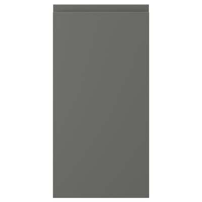 A VOXTORP cabinet door in dark grey with minimalist design and integrated handles.