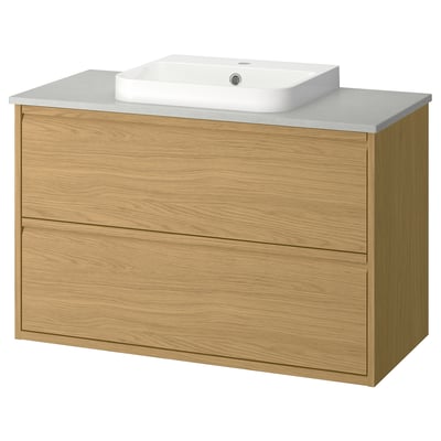 Modern oak bathroom vanity with minimalist design, wall-mounted with integrated handles and a light grey countertop holding a white ceramic basin.
