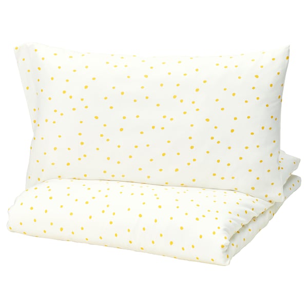 Barndrom pillow, yellow dots on white, rectangular shape.