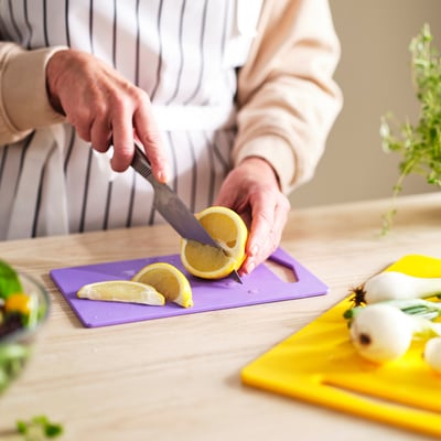 BERGTUNGA Cutting board, set of 2, bright yellow/lilac