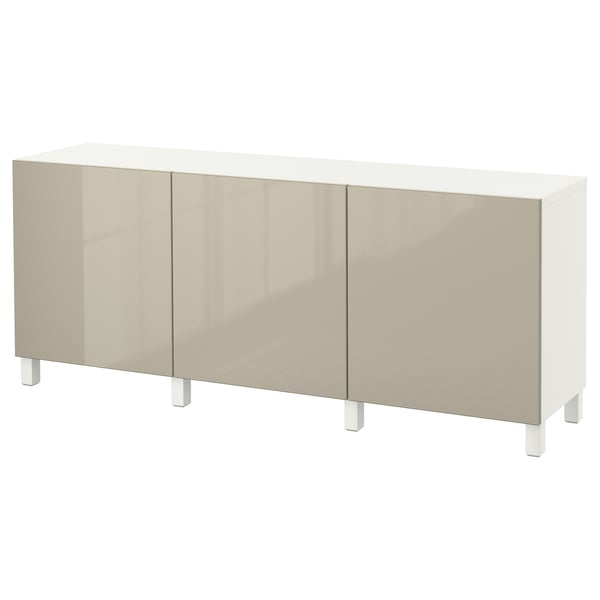 An ikea BESTÅ sideboard in white with beige glossy doors. It three adjustable shelves and four legs, displaying a sleek, modern design.