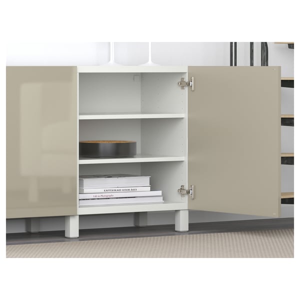 White open BESTÅ unit displays shelves with books and boxes, showcasing adjustable storage.