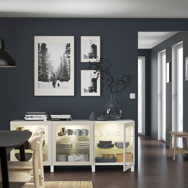 Modern living room with BESTÅ sideboard, framed pictures, and vase.