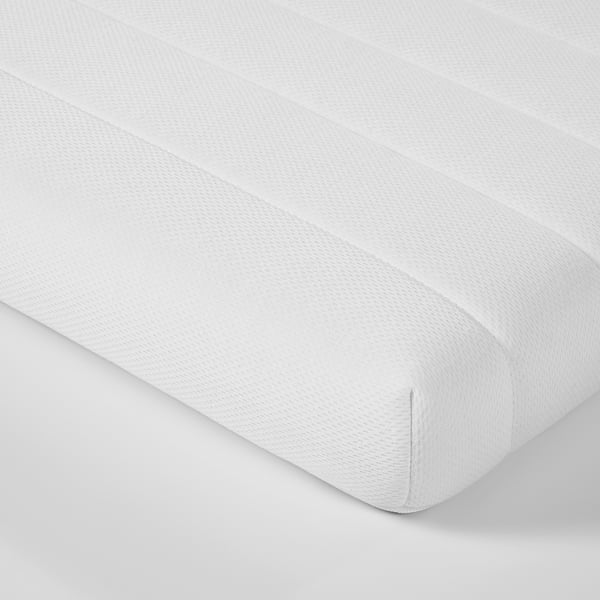 White mattress corner detail, showcasing quality craftsmanship, clean lines, and smooth fabric.