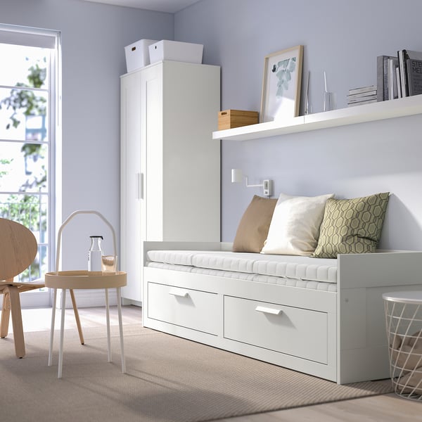 BRIMNES white day-bed with drawers & cushions, near cabinet & table, well-lit.