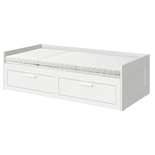 Displays a white BRIMNES day-bed with two drawers, suitable for small spaces. It converts from a sofa to a bed.