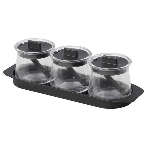 Three glass containers with black lids and spoons in a black tray. Its the CELEBRERA product, transparent and easy to clean.