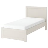 Off-white FÅGELFJÄLLET bed with sturdy footboard, decorative headboard, and white mattress.