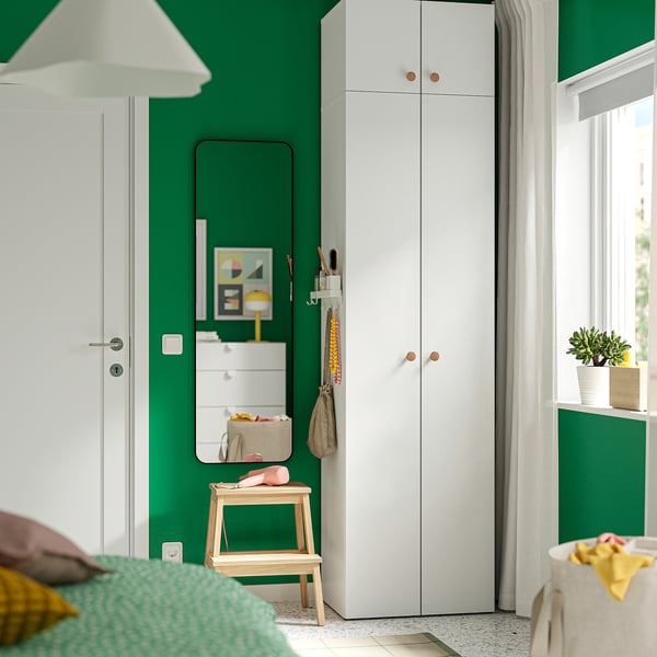 Modern kids room with white LASTARE wardrobe, green wall, window, mirror, stool, lamp, plants, colours.