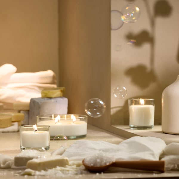 LOTSFÅGEL candles: white wax in glass cups, small & large sizes, lit & floating decorative bubbles.