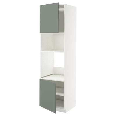 METOD kitchen units with light green doors and white shelves.