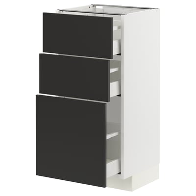 Modern kitchen unit with black drawers, white frame, sleek design.