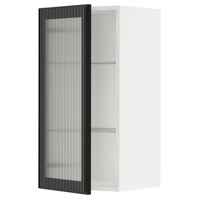 This image shows a modern white wall cabinet with a black glass door featuring vertical reeding. The cabinet has two glass shelves inside.