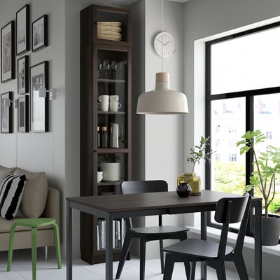 Modern dining room with OXBERG cabinet, table, chairs, large window, and art. Bright, cosy, stylish.