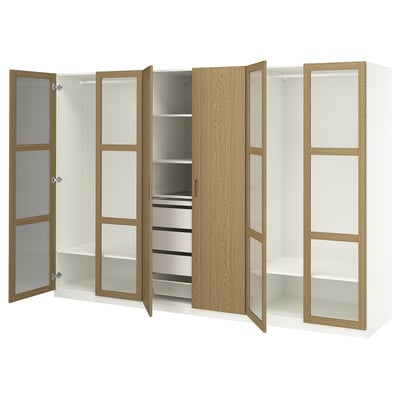 Displays an ikea PAX wardrobe in white and oak. It open doors revealing shelves and storage solutions.