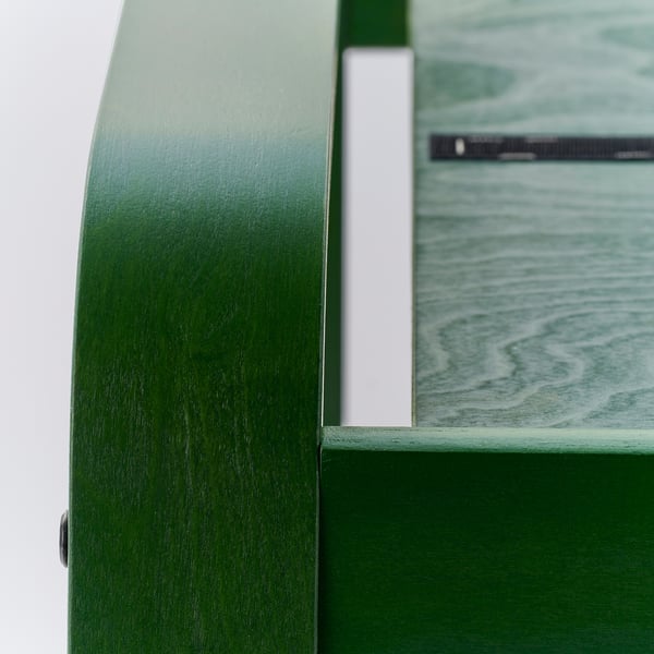 Close-up of POÄNG footstools durable frame and soft, wide-wale corduroy fabric.