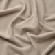 Close-up of soft, textured, beige fabric with subtle lustre and wide-wale corduroy pattern.