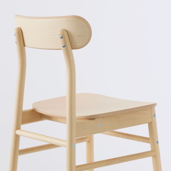 Minimalist chair with smooth, curved seat and backrest. Made of light wood, durable construction with visible screws.