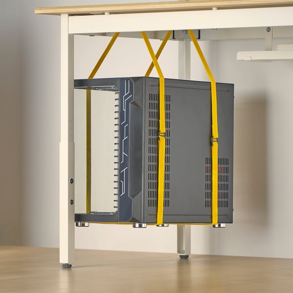 Gaming desk with tower straps: secures pc, saves space, promotes airflow.