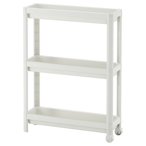 A white VESKEN storage trolley with three shelves, designed for narrow spaces, featuring a stable and mobile structure with wheels.