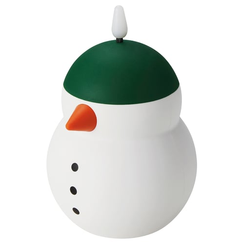 A VINTERFINT decorative snowman lamp. Its white, green, and orange, with a round body and a green hat. It produces a warm, glowing light.