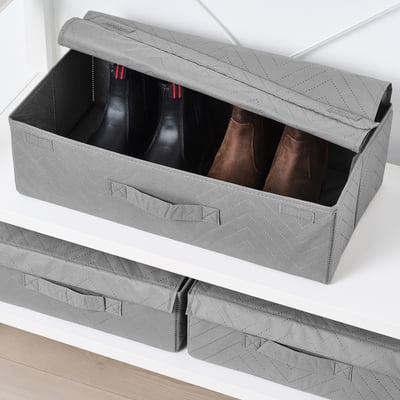 Grey FULLSMOCKAD storage box holding boots, perfect for closet organization.