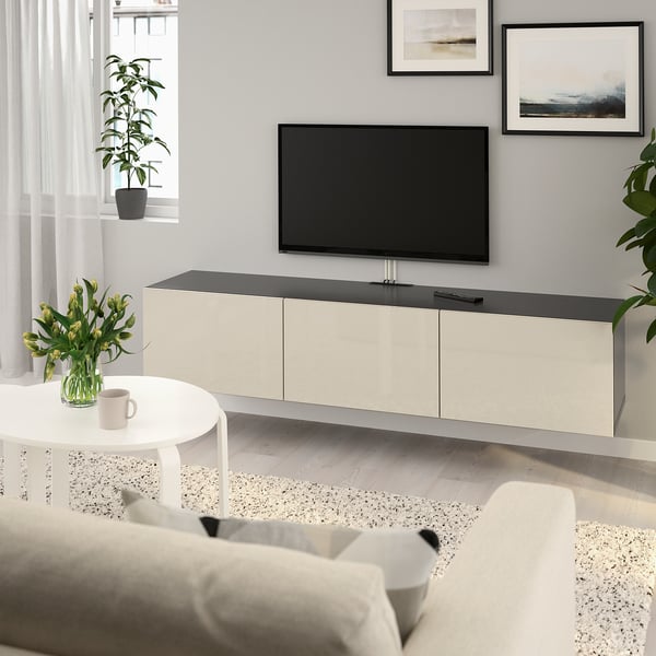 Modern living room with BESTÅ tv bench, art, & cozy decor.