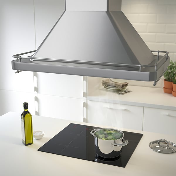 Modern stainless-steel kitchen hood, larger than surrounding items, with built-in led lights and spice rack.