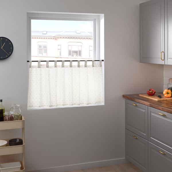 Kitchen: sheer curtain for privacy, tall cabinet, wall clock.