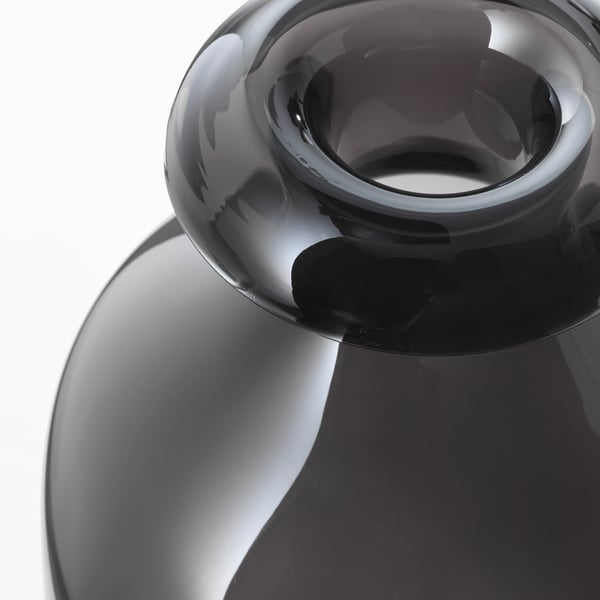 Dark glass vase, elegantly curved, showcasing fine craftsmanship.