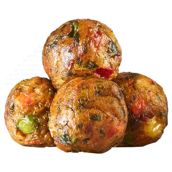 Four round, golden-brown fritters with visible bits of green and red, piled together, likely to be savory and crispy.